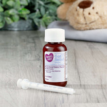 Infants' gas relief drops bottle with enclosed white dosing syringe, red liquid
