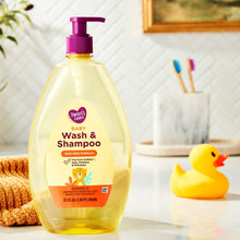 Baby Wash & Shampoo pump bottle with purple dispenser, beside a yellow rubber duck