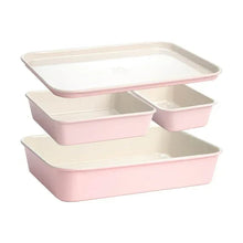 Pink ceramic nonstick 4-piece nested bakeware set with baking sheet and loaf pan