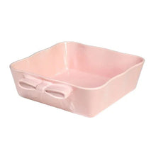 Pink ceramic square baking dish with bow handles, side view