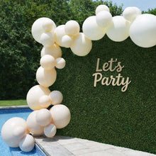 Sandy shades reusable PVC balloon garland arch with cream and white balloons outdoors