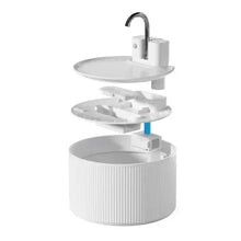 Ceramic-style pet water fountain with open internal filter stack and faucet
