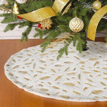 White plush Christmas tree skirt with gold feather-like pattern, round edge