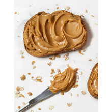 Peanut butter swirl on toast slice with scattered crumbs