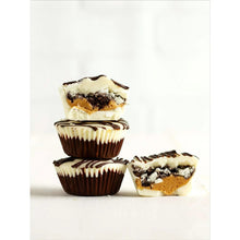 Stuffed cupcake with white icing and dark crumb topping