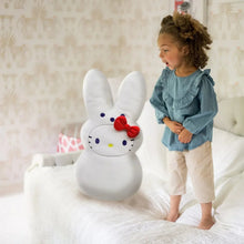 Jumbo plush rabbit with white fur, red bow, and cartoon face