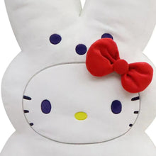 White bunny plush toy close-up: oval face with red bow and whisker dots