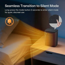 Black tabletop ceramic heater on a table with glowing warm airflow