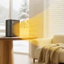 Black tabletop ceramic heater on a side table with visible warm air output