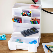 White plastic desktop organizer with pen compartments and a front drawer