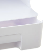 Close view of white plastic front drawer on a desk organizer