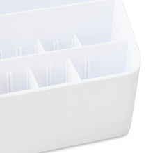 White plastic desktop organizer with curved side and multiple pen slots
