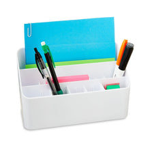 White desk organizer holding notebooks and markers in front compartments