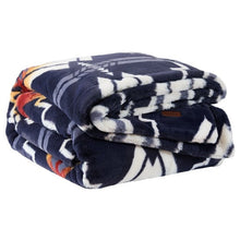 Folded Pendleton faux fur blanket with a plush navy and cream geometric pattern