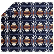 Pendleton faux fur blanket laid flat, displaying repeating cream, navy and rust geometric motifs
