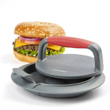 Red and gray burger press with hinged handle and round, ridged base