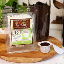 Paper filter cup with coffee grounds next to Perfect Pod filter pack on wood board