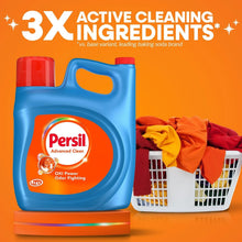 Laundry detergent jug, blue with red cap, next to folded towels in a basket