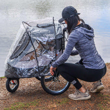 Pet stroller with clear rain cover and gray fabric base, black wheels