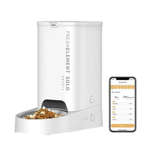 Smart pet food dispenser base with kibble bowl and app screen on smartphone