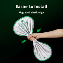 Folded white cat litter pad showing elastic edge and reinforced green-trim border