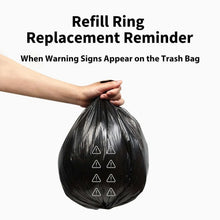 Black waste bag held in a hand with small warning icons printed on it