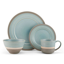 Blue stoneware dinner plates with speckled glaze and matching mugs.