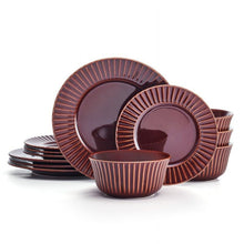 Red stoneware dinnerware set with ribbed plates and nesting bowls