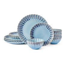 Blue stoneware dinnerware set with scalloped plates and matching bowls