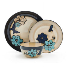 Stoneware dinner plate with butterfly blue floral pattern on cream background and dark rim