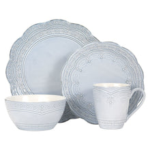 Blue stoneware dinnerware set: plates, bowl, and mug with ornate lace trim