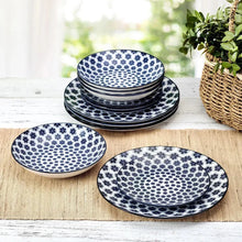 Porcelain dinnerware set with blue and white oval plates, floral dot pattern