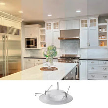 Round white LED downlight in kitchen ceiling with visible mounting ring