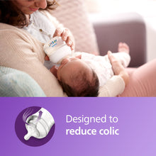 Parent holding a Natural baby bottle for feeding, first flow nipple