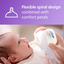 Baby drinking from a white Natural baby bottle with nipple