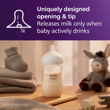 Philips Avent Natural Response baby bottle with white nipple, standing on table