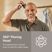 Electric head shaver in use against scalp with four foil shaving heads
