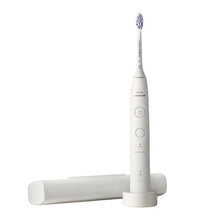 White rechargeable electric toothbrush standing on charging base