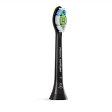 Black replacement toothbrush head with white bristles and blue and green inserts.