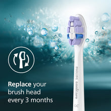 Replacement brush head with purple and blue bristles under bubble spray