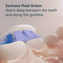 Philips Sonicare brush head with blue bristles shown over foamy water