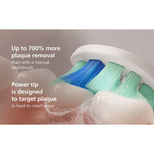 Sonicare brush head with soft blue and green bristle clusters, wet with water
