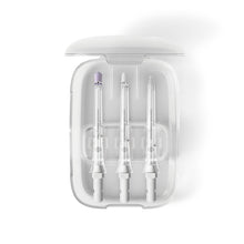 Clear storage compartment holding three transparent flosser nozzles