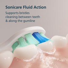 Toothbrush head with multi-color bristles producing foamy cleaning spray