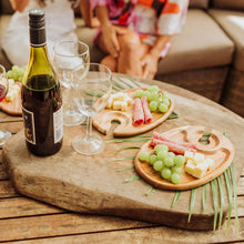 Wooden oval appetizer plates with handle notches, on table with cheese and grapes