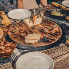 Acacia wood lazy Susan serving tray with sliced bread, cheese, and berries on top