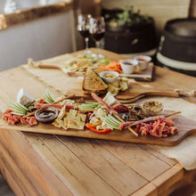 Acacia charcuterie board with assorted vegetables, meats, and breads