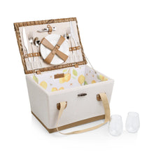 Open wicker picnic basket with lemon liner, utensils, and two cups
