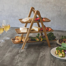 3-tier wooden serving ladder with food on three shelves