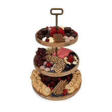 3-tier wooden serving tray with berries, cookies, and assorted desserts on round tiers